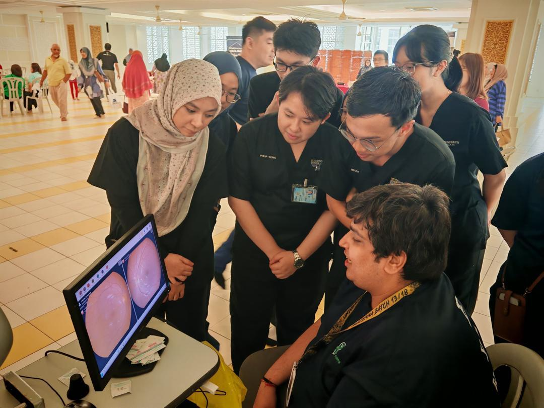 A group of people looking at a computer screen AI-generated content may be incorrect.